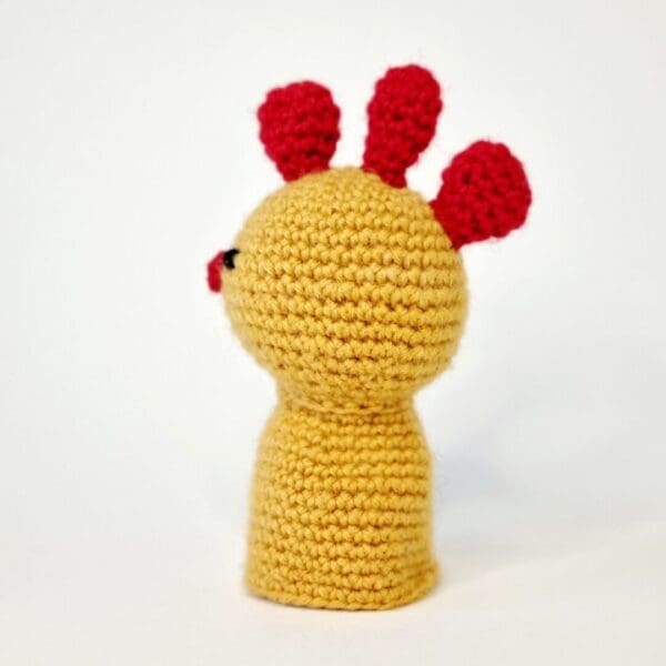 Side angle of a crochet chicken egg cosy