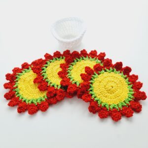 Crochet flower coasters set with white storage pot. Yellow middle, green stems and red clusters to symbolise roses.