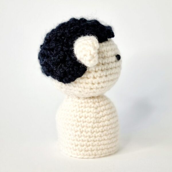 Side view of a rochet sheep egg cosy