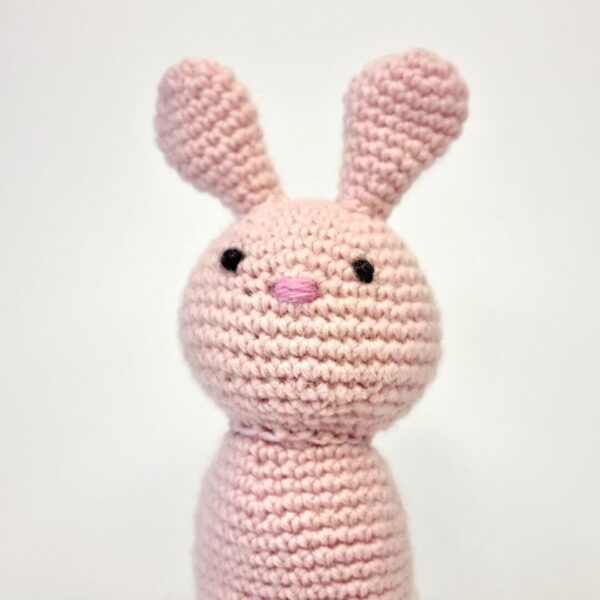 Close up shot of a pink crochet bunny rabbit