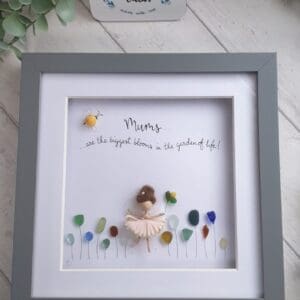 Sea glass picture of a Mor Maids fairy in a sea of wild flowers with a bumblebee maid using a periwinkle shell and the quote 'Mums are the biggest blooms in the garden of life'