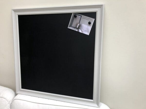 A large magnetic blackboard with traditional style frame painted in Pavilion Gray, by FramedNoticeBoardCompany