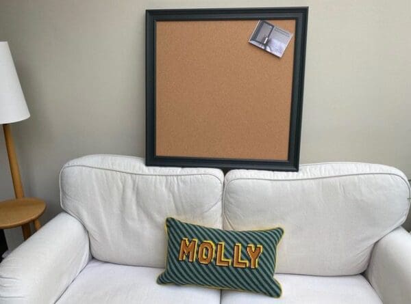 An extra large cork pin board with dark green frame