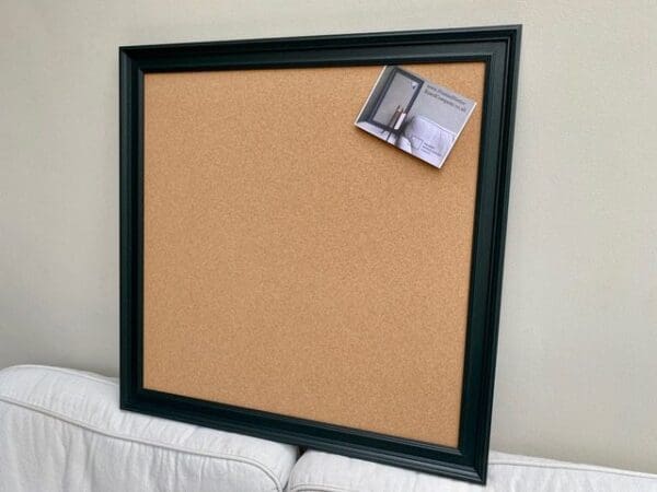 A large cork pin board with dark green frame, by FramedNoticeBoardCompany