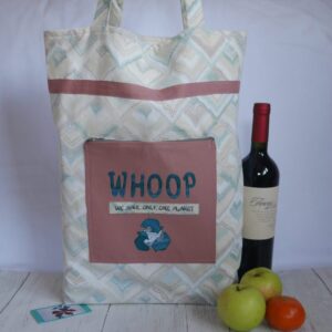Cream coloured tote bag with dusky pink front pocket and trim, shown with assorted fruit and bottle of wine