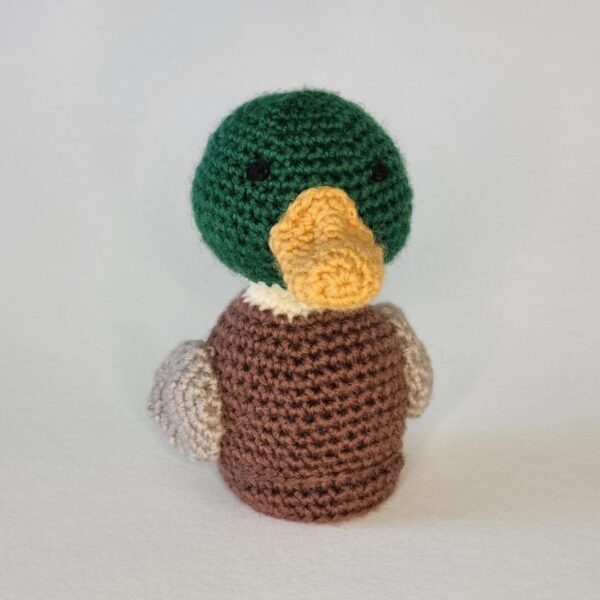 A crochet mallard duck on a white background