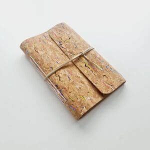 Cork fabric notebook with rainbow fleck pattern by Sarah Lou Crafts.