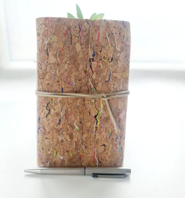 Cork fabric notebook with rainbow fleck pattern by Sarah Lou Crafts.