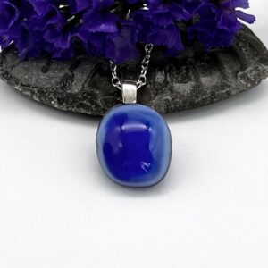 blue free form shape fused glass cabochon mounted on silver on a silver chain