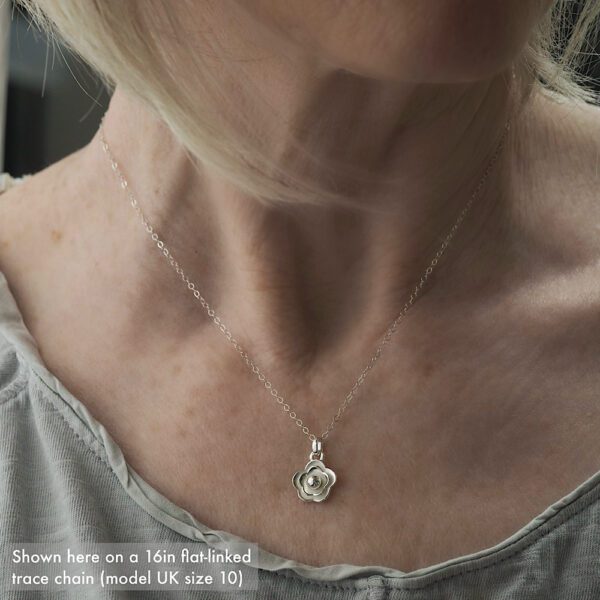 Handmade 11mm diameter Sterling silver flower pendant necklace shown on a 16in silver trace chain