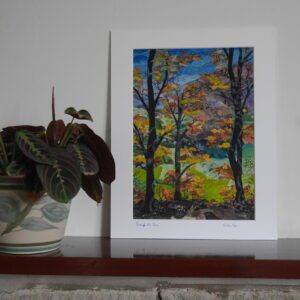 Print of textile art woodland scene in white surrounding mount and shown beside a pot plant