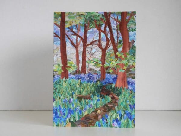 Greetings card showing print taken from textile art picture of wood with bluebells and path through them