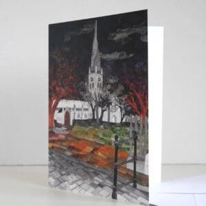 Greetings card showing textile art picture of Chesterfields crooked spire in the winter at night, with white envelope