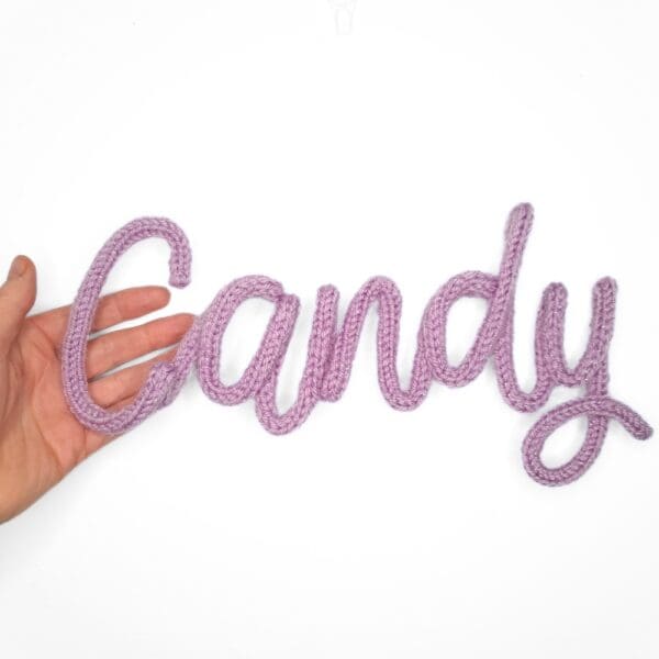 Knitted wire Halloween decoration with the word 'Candy'