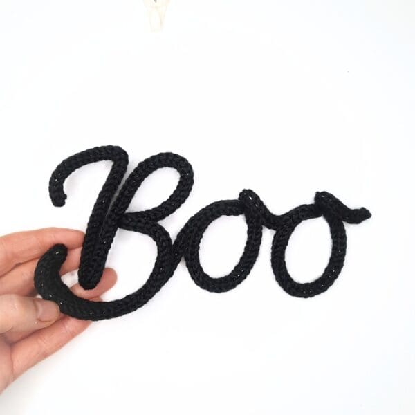 Knitted wire Halloween decoration with the word 'Candy'