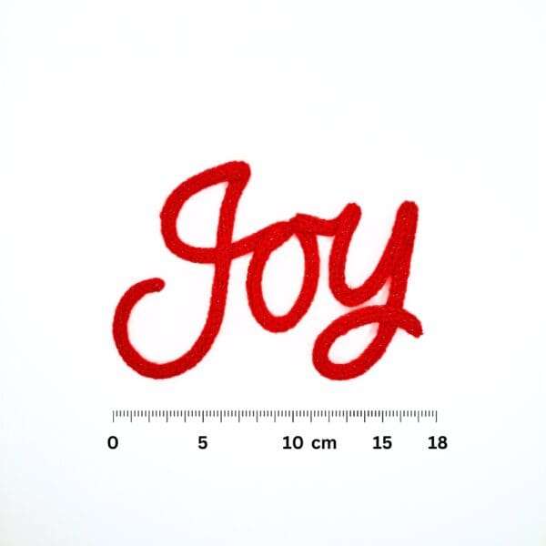 Knitted wire Christmas decoration with the word 'Joy'