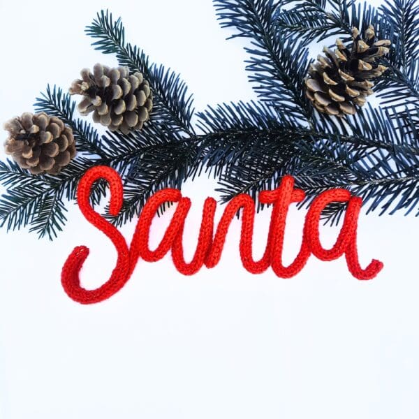 Knitted wire Christmas decoration with the word 'Santa'