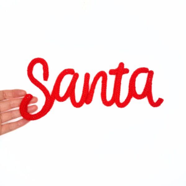 Knitted wire Christmas decoration with the word 'Santa'