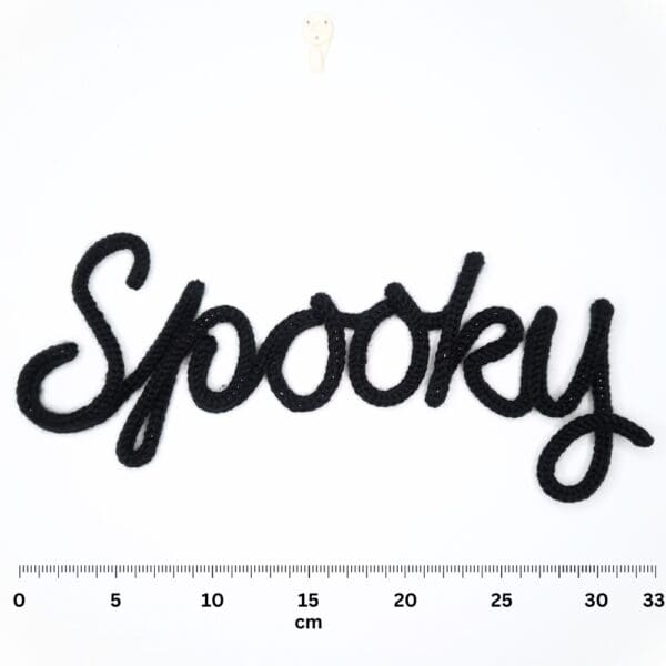 Knitted wire Halloween decoration with the word 'Spooky'