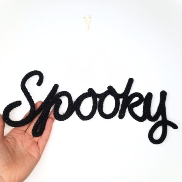 Knitted wire Halloween decoration with the word 'Spooky'