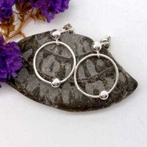 silver hoop with moveable silver bead on stud earrings