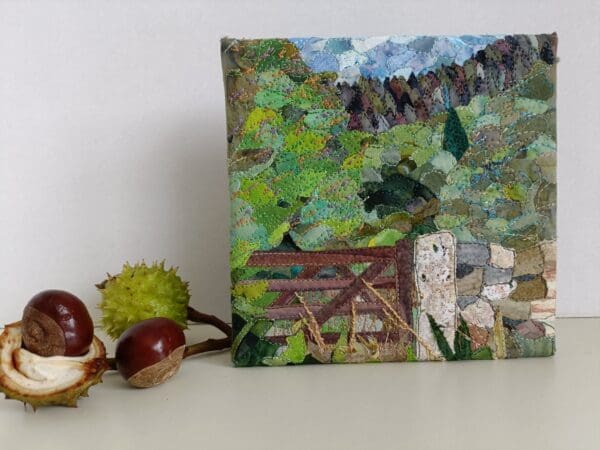 Front view of textile art collage shown with horse chestnuts as props for scale.