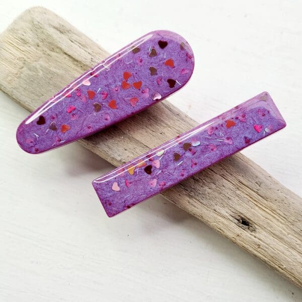 Pair of pink sparkly heart resin hair clips