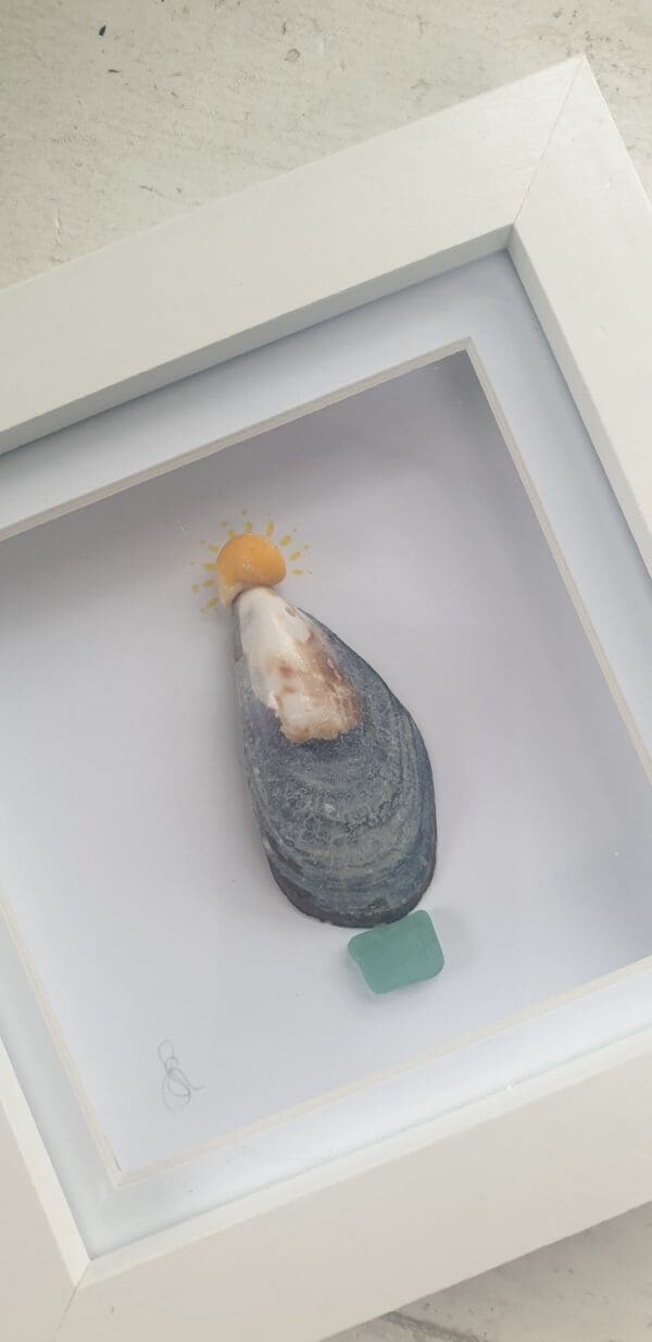 Christmas tree picture made with a mussel shell and periwinkle shell