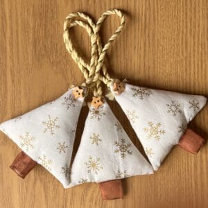 Christmas tree shaped fabric decoration against a teak background