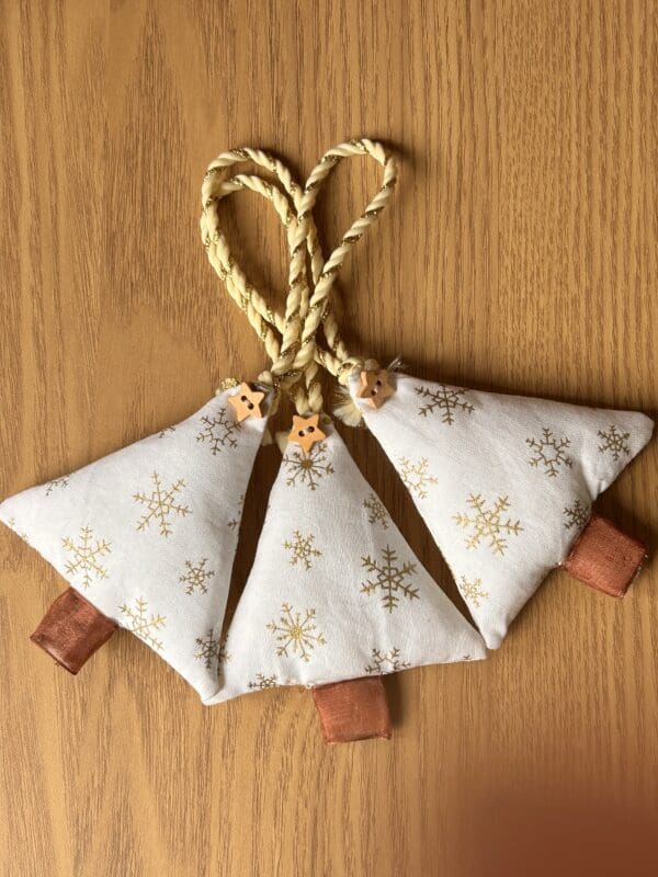 Christmas tree shaped fabric decoration against a teak background