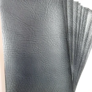 Black faux leather pieces, pre cut rectangles shown in a fanned pile on a white table.