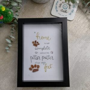 Pawprint seaglass picture with quote 'A home is not complete without the pitter patter of our dogs feet'