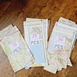 Map paper scraps shown in tied bundles of 10, 20 or 30 pieces put together by Sarah Lou Crafts.