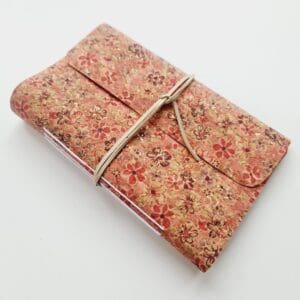 Cork fabric notebook journal with pink floral pattern and cream faux suede wrap tie, made by Sarah Lou Crafts.