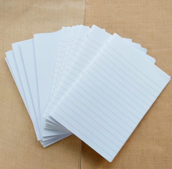 Photo showing choices of plain white or lined pages for cork notebooks by Sarah Lou Crafts.