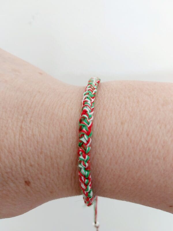 Close up of Welsh thread bracelet on wrist by Sarah Lou Crafts.