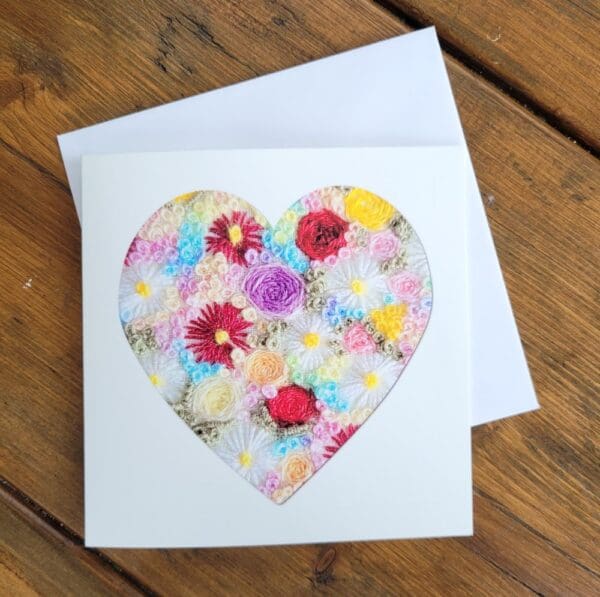 Valentines card print of original embroidery of heart filled with embroidered flowers.