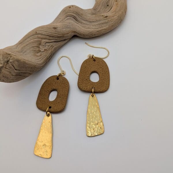 Abstract statement dangle earrings with brass charms.