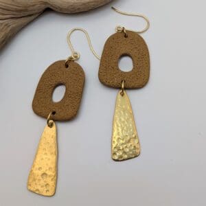 Abstract statement dangle earrings with brass charms.