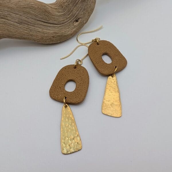 Abstract statement dangle earrings with brass charms.