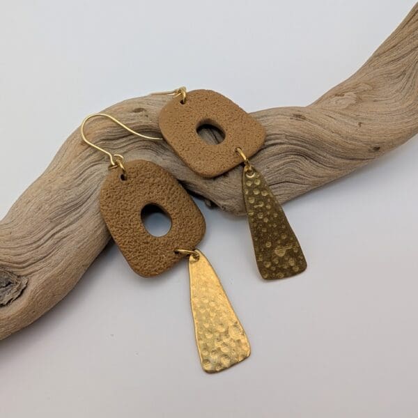 Abstract statement dangle earrings with brass charms.