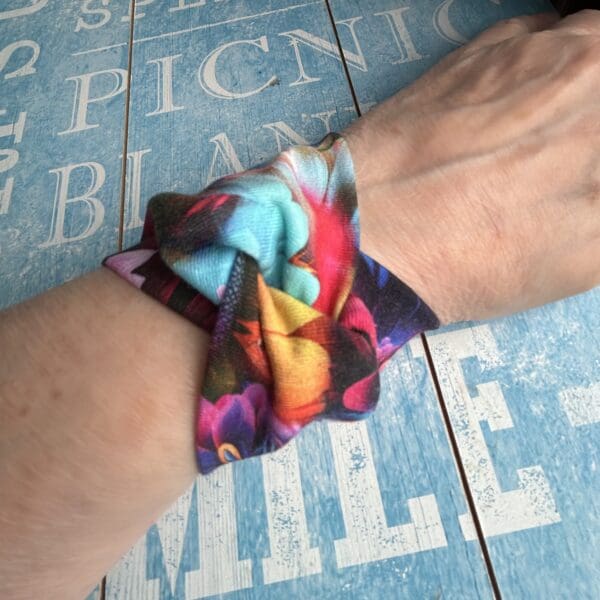 Tropical bold floral fabric cuff bracelet with twist design modelled by creator
