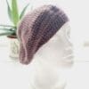 Crochet beret made by Sarah Lou Crafts using an aran yarn called Grape. Shown on white mannequin head with plant in back ground.