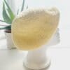 Side view image of a yellow cotton crochet beret hat. The circular shape is clearly visible, with the crown gathered at the top. The brim is defined and consistent.
