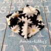 Daisy print fabric bracelet in a black with white daisy flower.