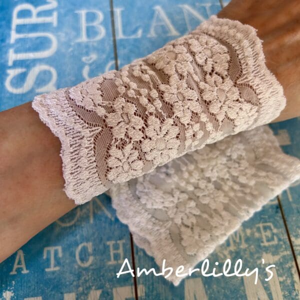 White cuffs one pair with floral design shown against a blue background