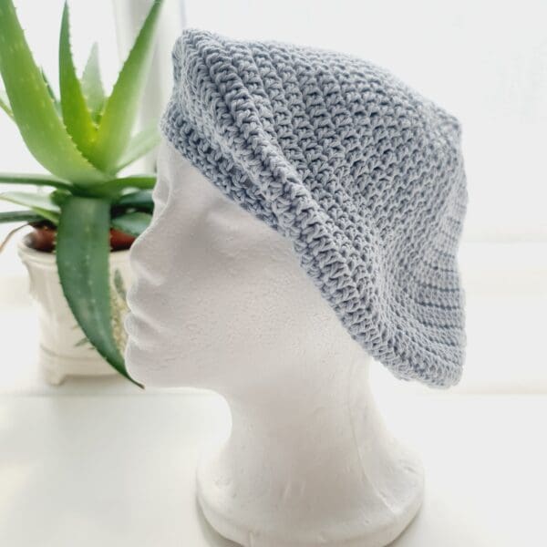 Elegant pastel blue crochet beret hat with a subtle ribbed brim, made by Sarah Lou Crafts.