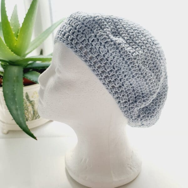 Stylish pastel blue crochet beret hat, made by Sarah Lou Crafts. Perfect for a chic and cosy look.