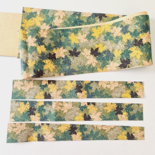 Cork fabric scrap pieces with a Green Leaves design and plain cream backing that can be used for craft projects.