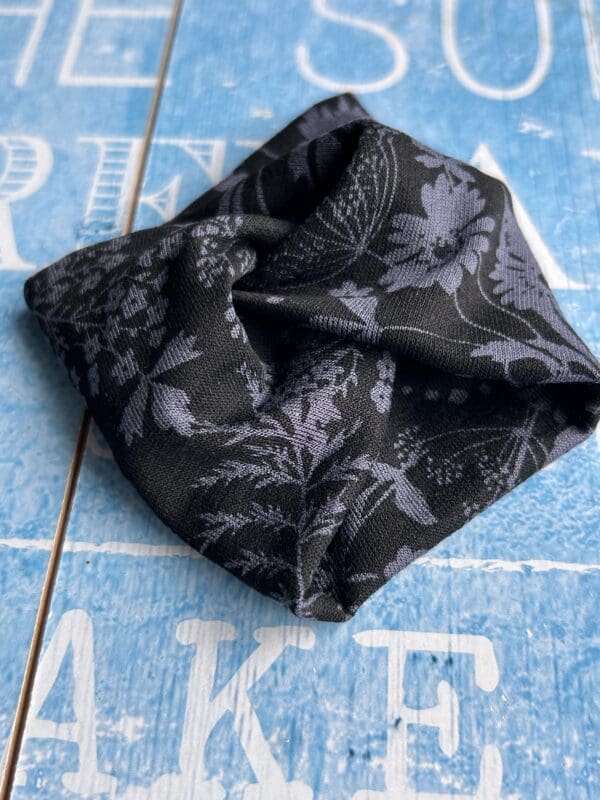 Black fabric cuff bracelet with wildflower design in grey